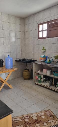 a kitchen with a counter and a table in a room at Lucena House in Lucena