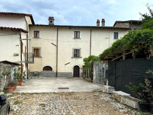 a large white building with a gate in front of it at Borgo Residence at Tagliacozzo in Tagliacozzo