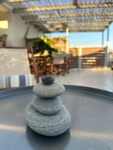 a stack of rocks sitting on top of a table at KYMA sea view apartment 40 meters from the beach in Makry Gialos