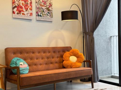 a teddy bear sitting on a couch in a room at 1506 SkyTree Bukit Indah Aeon 1min in Johor Bahru