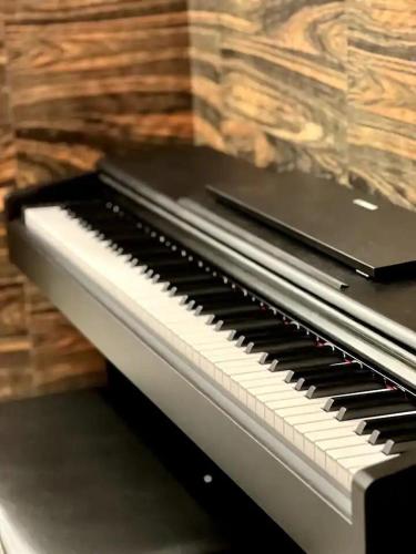 a laptop sitting on top of a piano at 1506 SkyTree Bukit Indah Aeon 1min in Johor Bahru
