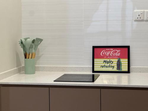 a laptop sitting on a counter with a sign on it at 1506 SkyTree Bukit Indah Aeon 1min in Johor Bahru