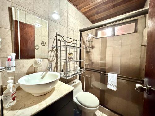 a bathroom with a sink and a toilet at Casa independiente de un piso en Barva Heredia Costa Rica in Barva