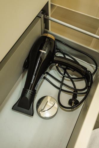 a black hair dryer sitting on top of a counter at Dosoftei Residence in Chişinău