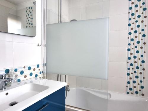 a bathroom with a white tub and a sink at Port-Vendres - Appartement F3 avec parking et WIFI - FR-1-309-241 in Port-Vendres