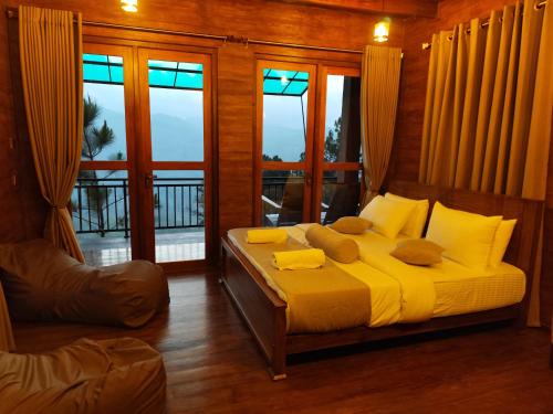 a bedroom with a bed with yellow sheets and pillows at Miracle view Ella in Ella