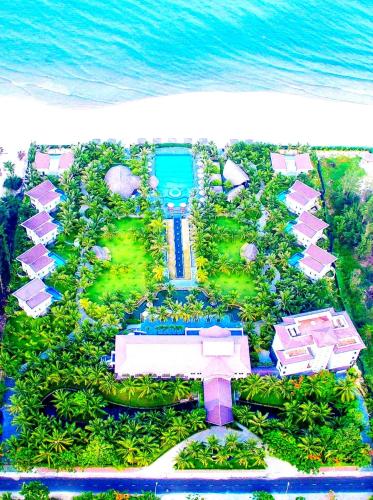 an aerial view of a resort with the ocean at Sonata Resort & Spa in Phan Thiet