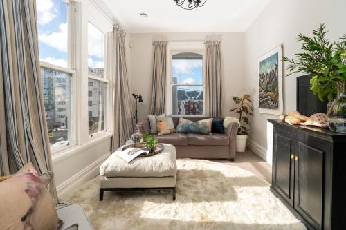 a living room with a couch and a table at 2 Bedroom Apartment where Modern Luxury meets Historic charm in Wellington