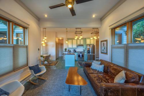 a living room with a couch and a table at Historic Hood River Retreat with Stunning Gorge Views - Roe Parker House in Hood River