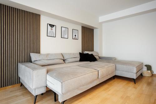 a bedroom with a large bed and a couch at Dosoftei Residence in Chişinău