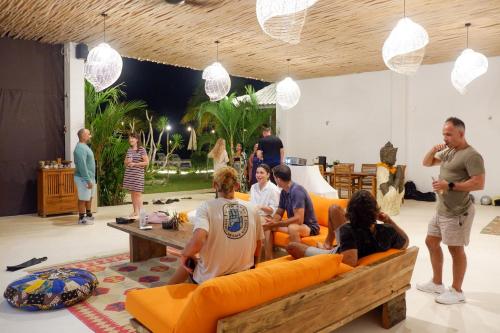 a group of people sitting on couches in a room at Sukacita Hill in Uluwatu