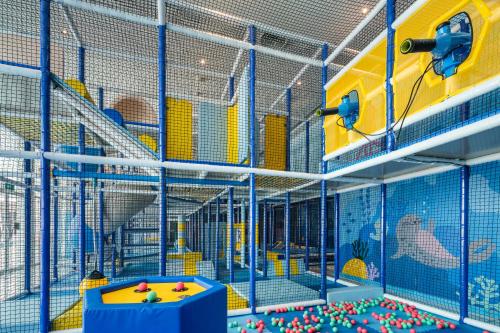 a large cage with a play area with toys in it at Holiday Inn Pattaya by IHG in Pattaya Central