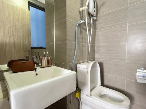 a bathroom with a toilet and a sink and a shower at The Cosmic - Icon City Petaling Jaya in Petaling Jaya