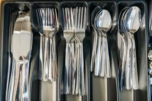a group of forks and spoons in a drawer at Peaceful Private backyard w BBQ in Lombard by LCP Collection in Lombard