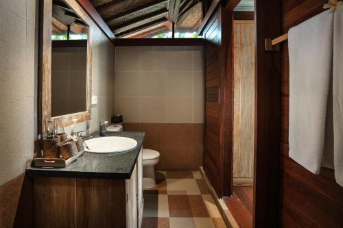 a bathroom with a sink and a toilet at Yana Villas Kemenuh by GenuineHost in Ubud