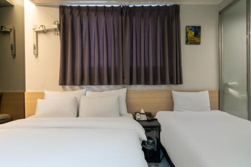 two beds sitting next to each other in a room at Mnlucky Hotel in Seoul