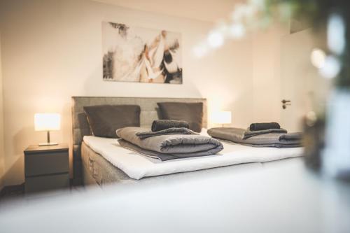 two beds with pillows on them in a bedroom at Exklusives Apartment Sinsheim Luxus, 75 TV & Top Lage WeHome Premium in Sinsheim