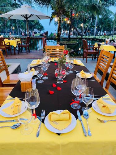 a table with wine glasses and napkins on it at Sonata Resort & Spa in Phan Thiet