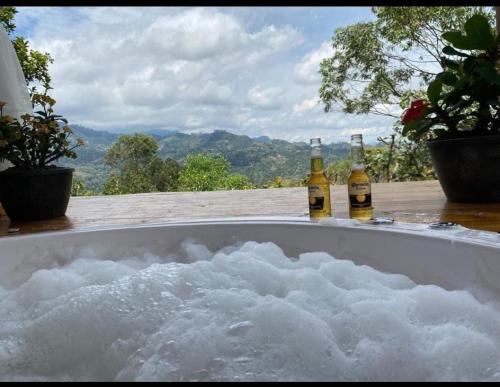 two bottles of beer sitting in a bath tub at Cabaña Luz de Luna in San Francisco