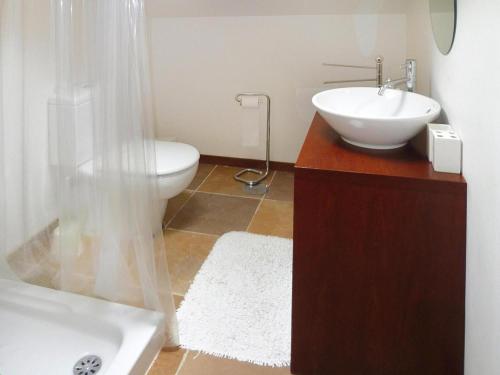 a bathroom with a sink and a toilet at Granite House by Tâmega with Pool in Luzim