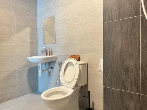 a bathroom with a toilet and a sink at The Ruby - Subang Jaya Edumetro SEGi College in Subang Jaya