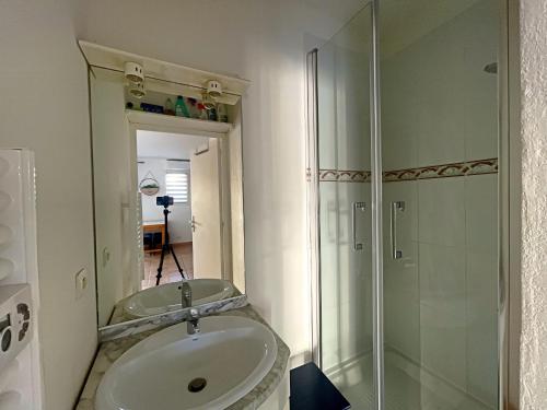 une salle de bain avec un lavabo et une douche en verre dans l'établissement Appartement 4 pers aux Saintes-Maries-de-la-Mer avec Cour et Parking - FR-1-475-150, à Saintes-Maries-de-la-Mer