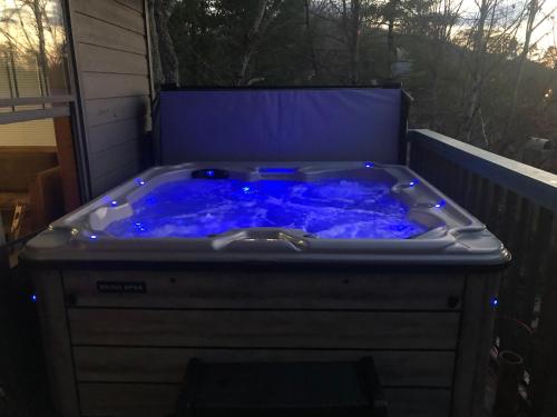 a jacuzzi tub with blue lighting in a backyard at Majestic Poolside Lookout in Pigeon Forge