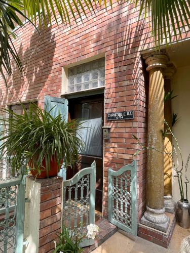 a brick building with a gate and a sign on it at Zaza Stay in New Delhi