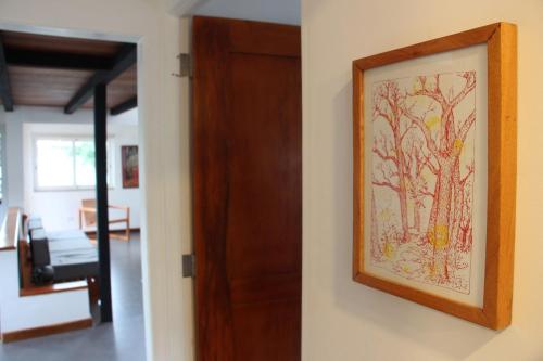 a painting of trees on a wall next to a door at CASA DINIS - Loft - With View Bahia de Portobelo in Portobelo