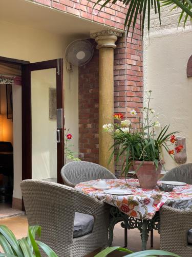 a table and chairs on an outdoor patio at Zaza Stay in New Delhi
