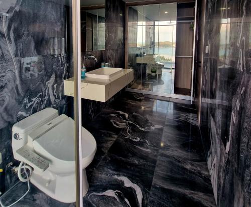 a bathroom with a toilet and a sink at Ocean View Luxury Retreat - Private Villa by Nest Group in Nha Trang