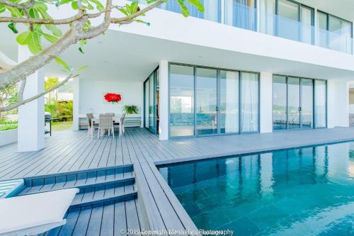 a house with a swimming pool and a deck at Ocean View Luxury Retreat - Private Villa by Nest Group in Nha Trang