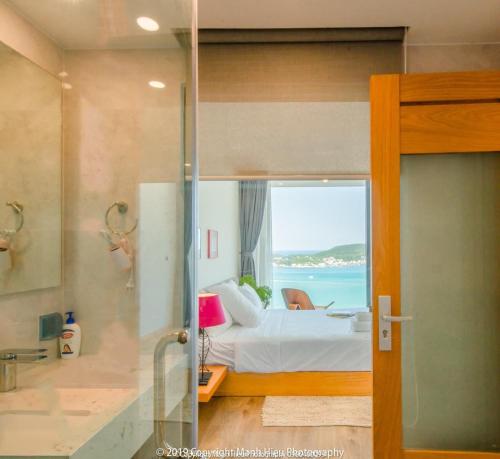 a bedroom with a bed and a view of the ocean at Ocean View Luxury Retreat - Private Villa by Nest Group in Nha Trang