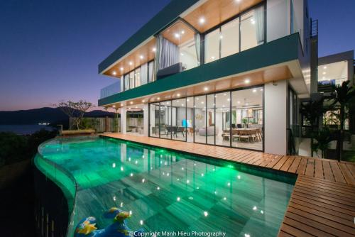 a large house with a swimming pool in front of it at Ocean View Luxury Retreat - Private Villa by Nest Group in Nha Trang