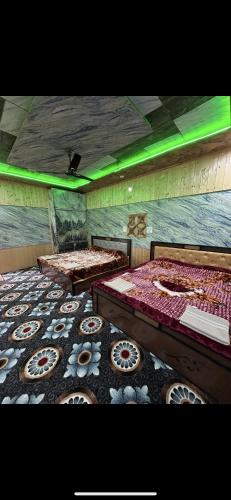 a room with two beds with donuts on the floor at Hotel sea face in Srinagar