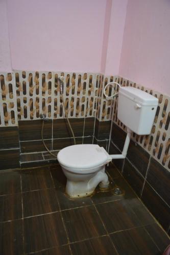 a bathroom with a toilet in a room at S M Residency in Mayiladuthurai