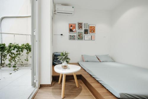 a room with a bed and a table at 4Brs 20mToHoanKiemLake Central Private OldQuarter in Hanoi