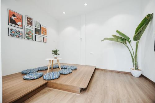 a room with a table with pillows and a plant at 4Brs 20mToHoanKiemLake Central Private OldQuarter in Hanoi