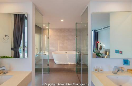 a bathroom with two sinks and a bath tub at Ocean View Luxury Retreat - Private Villa by Nest Group in Nha Trang