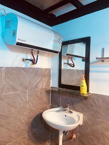 a bathroom with a sink and a mirror at Fish Farm Homestay in Yên Bái