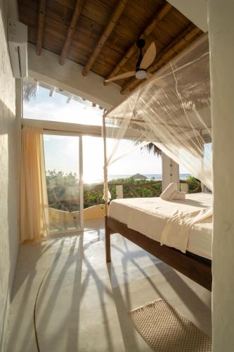 a bedroom with a bed and a large window at Tierra Munay in Las Tunas