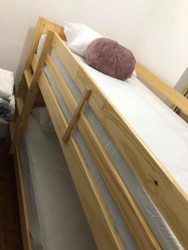 a wooden bunk bed with a pillow on it at Apartamento cerca a Parque de Bello Antioquia in Bello