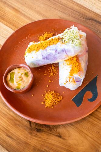 a plate of food with eggs and sauce on a table at Tierra Munay in Las Tunas