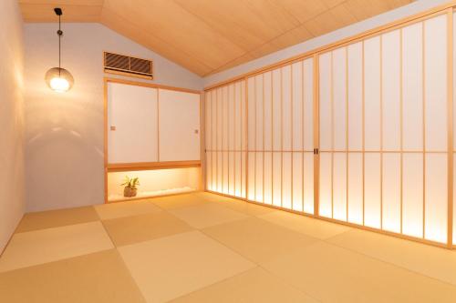 an empty room with a large window and a tiled floor at Private luxury villa with ocean view Shodoshima in Shodoshima