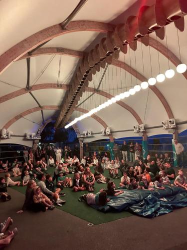 a large group of people sitting on the floor in a tent at BIG4 Apollo Bay Pisces Holiday Park in Apollo Bay
