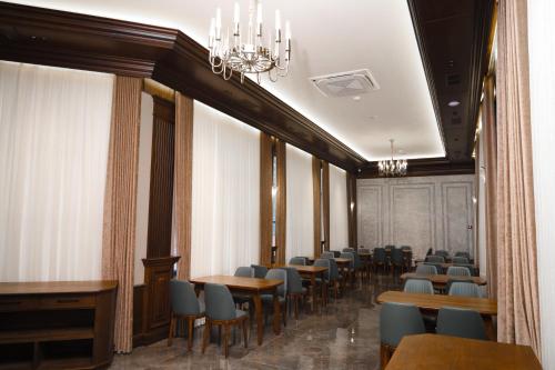 a row of tables and chairs in a room at Aliz Boulevard Hotel in Samarkand