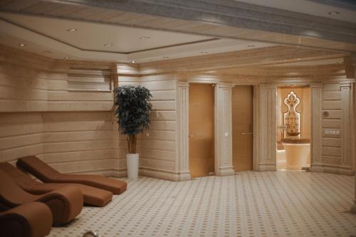 a large room with a plant in the middle of it at Aliz Boulevard Hotel in Samarkand
