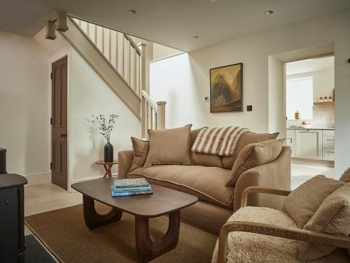 a living room with a couch and a table at Eskdale Retreat in Holmrook