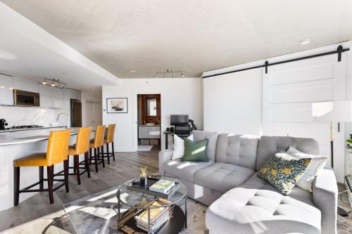a living room with a couch and a table at Luxury Central Apartment with City Views in Vancouver