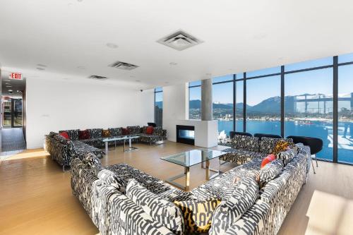 a living room with couches and a view of the city at Luxury Central Apartment with City Views in Vancouver